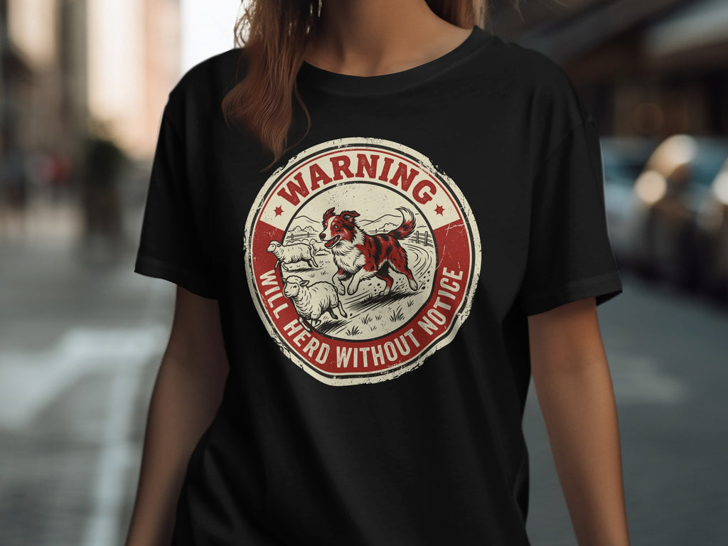 Circular graphic with dog herding sheep, reads "WARNING WILL HERD WITHOUT NOTICE".