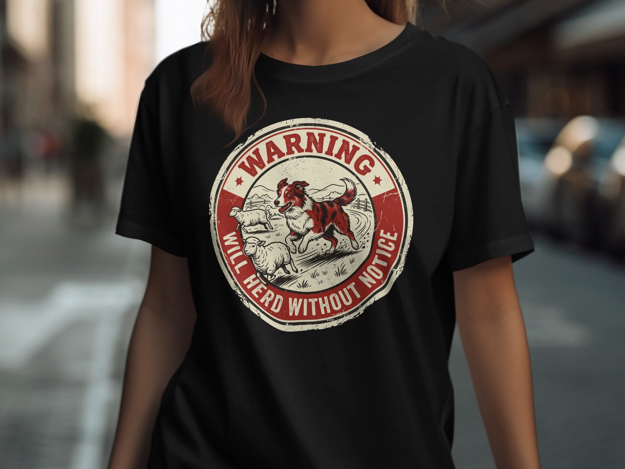 Circular graphic with dog herding sheep, reads "WARNING WILL HERD WITHOUT NOTICE".