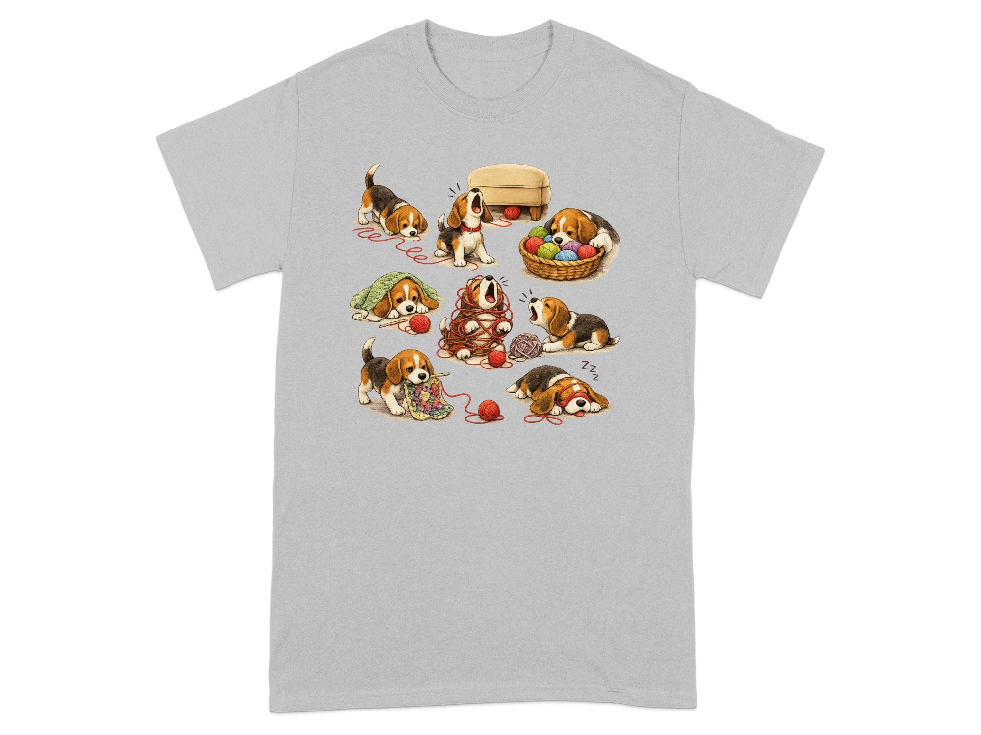 Several beagle puppies play with and get tangled in balls of yarn on a grey t-shirt.