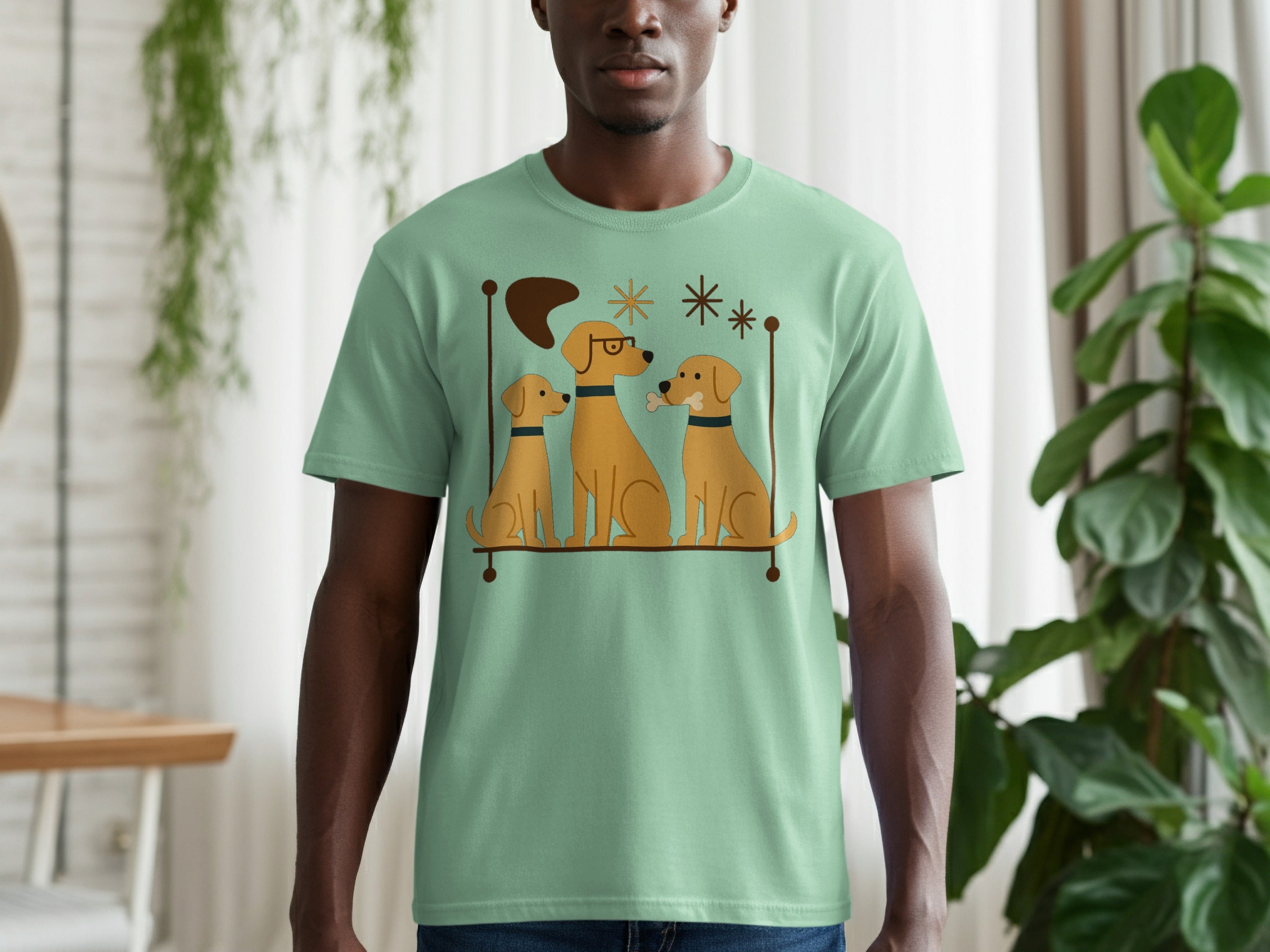 Mint green t-shirt with a graphic of three cartoon dogs and retro-style starbursts.