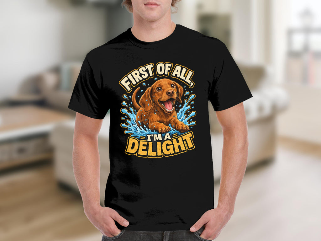 Black t-shirt with a playful dachshund puppy in water, text reads "First of all, I'm a delight."