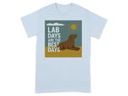 Light blue t-shirt with graphic of brown dog, sun, clouds, and text "LAB DAYS ARE THE BEST DAYS".
