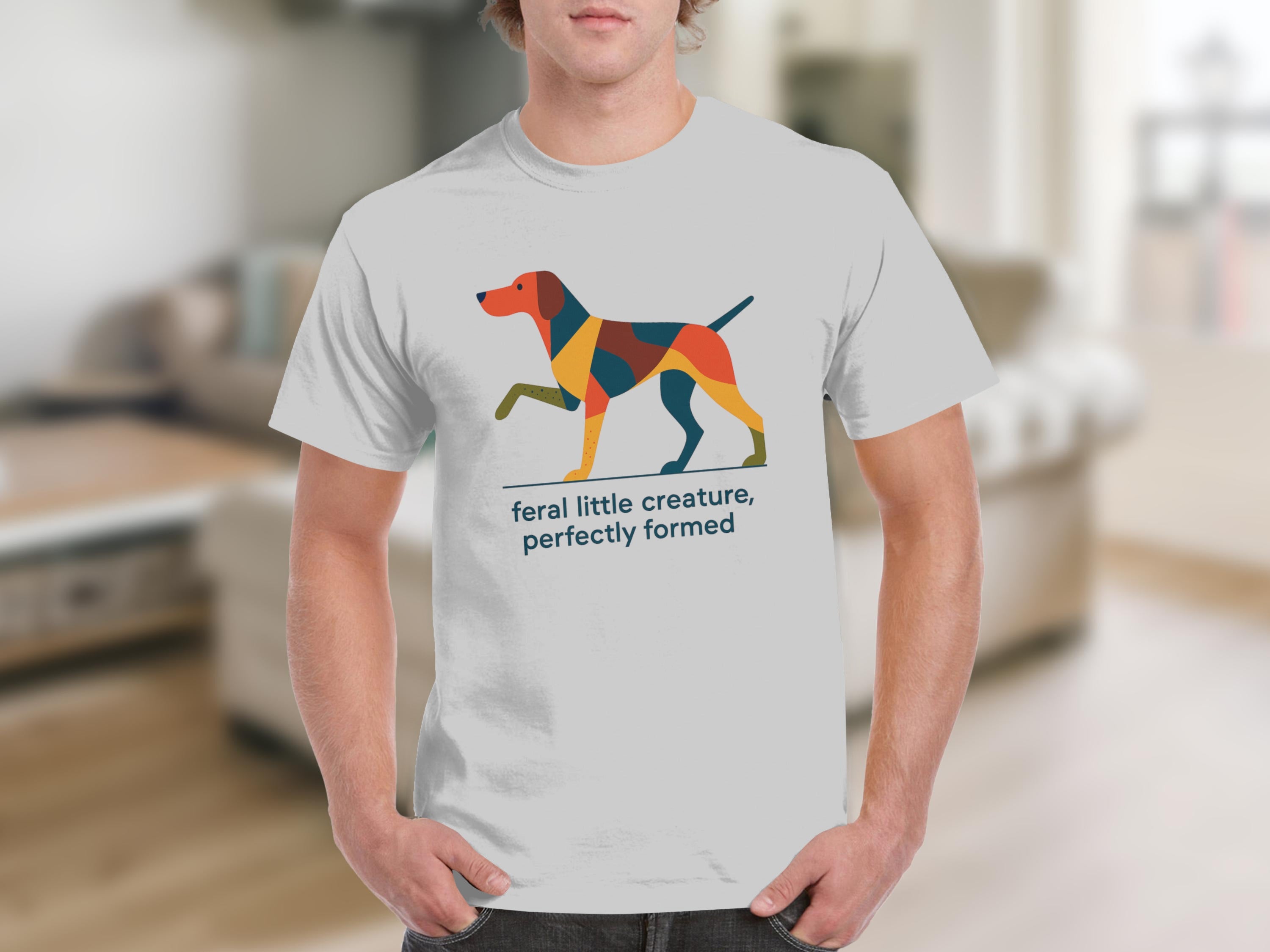 White t-shirt with abstract dog design and text "feral little creature, perfectly formed".
