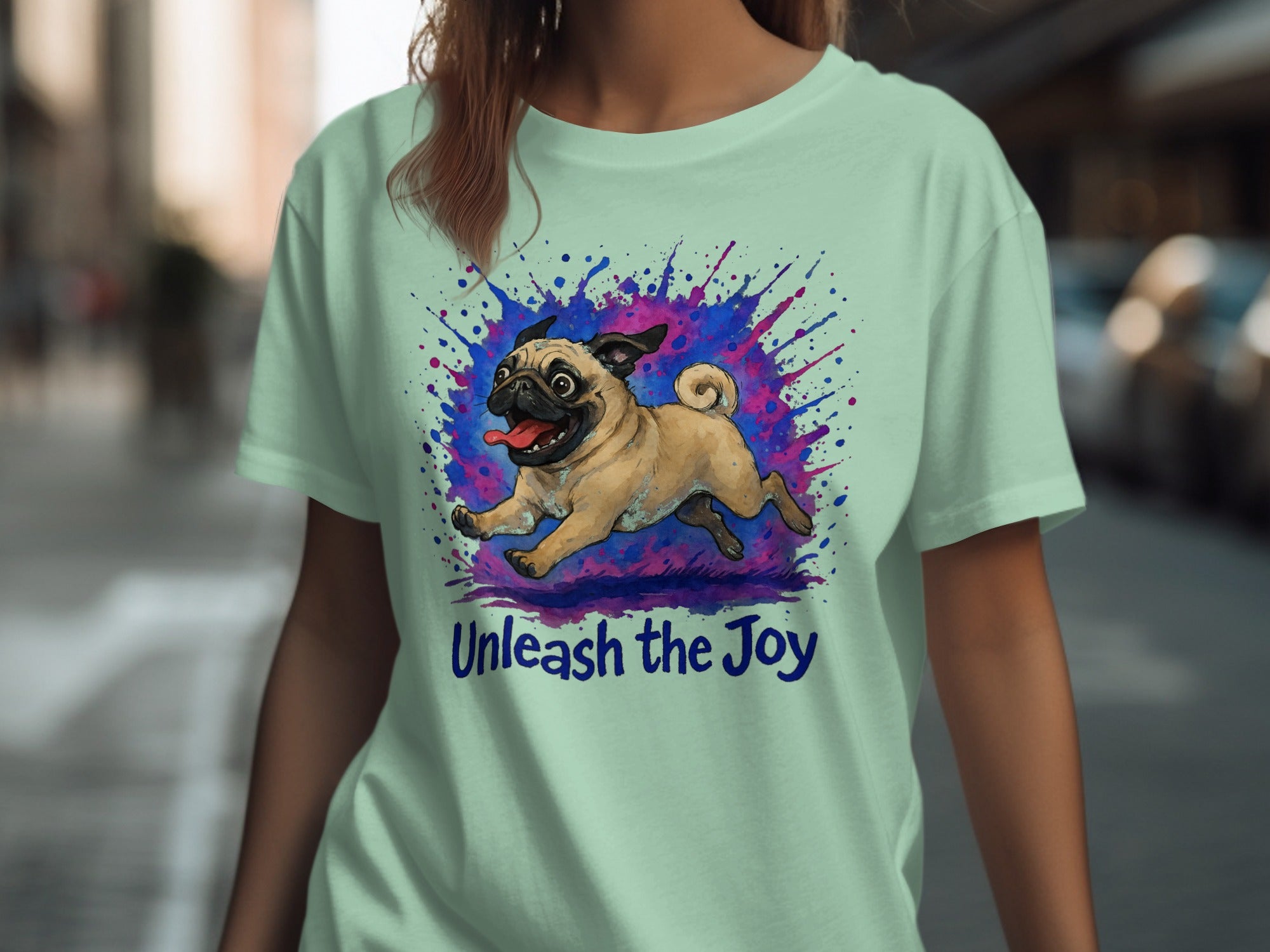 Light mint t-shirt with a pug illustration and "Unleash the Joy" text.