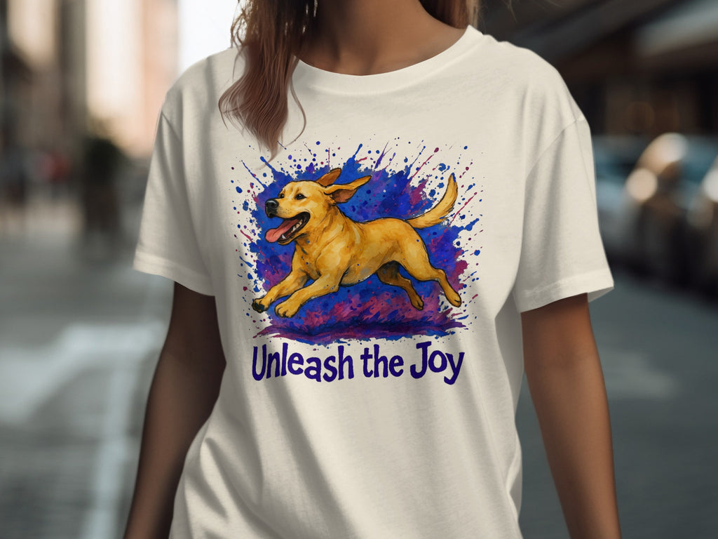 White t-shirt with running yellow dog graphic and text "Unleash the Joy."
