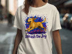White t-shirt with running yellow dog graphic and text "Unleash the Joy."