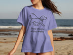 Lavender t-shirt with black outline of dog on leash and text "Slow down, enjoy walks".