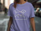 Purple t-shirt with a cream outline of a dog and text "Slow down, enjoy walks."