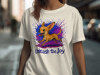 White t-shirt with cartoon chihuahua and "Unleash the Joy" text.