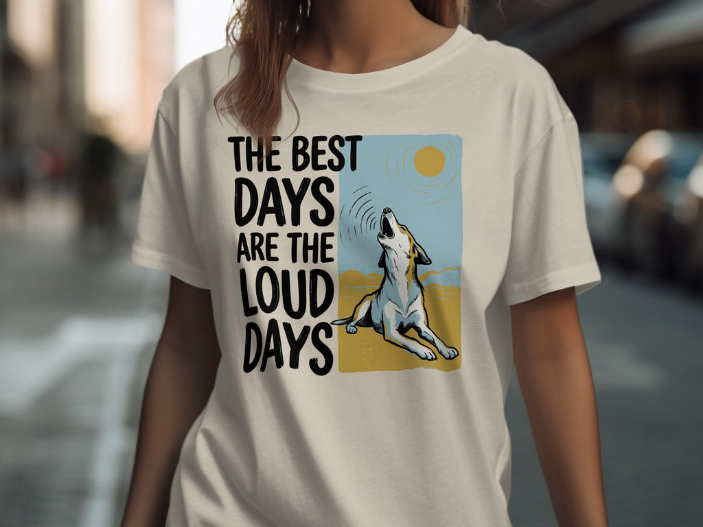 Cream t-shirt with graphic of a wolf howling at sun and text "The best days are the loud days".