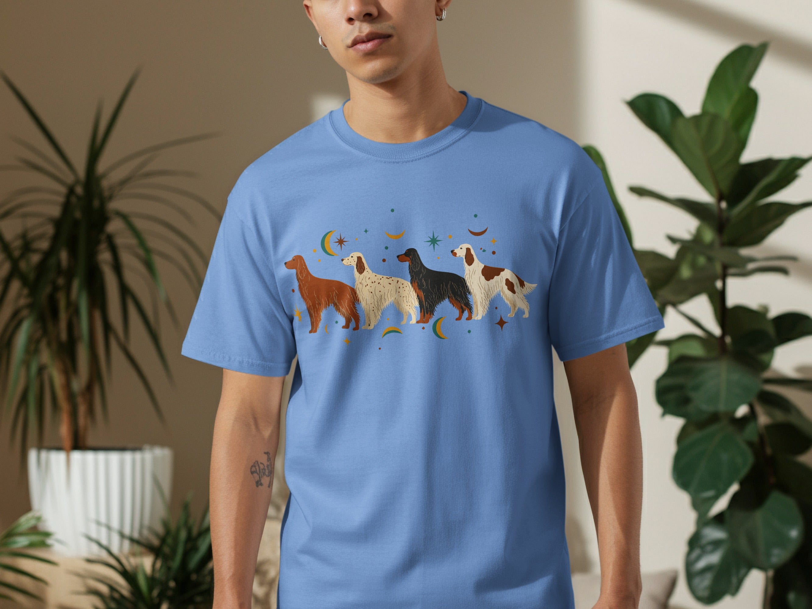 Blue t-shirt with four dogs in a line and stars.