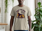 Beige t-shirt with a cartoon dog smelling something and text "TRUST THE NOSE".