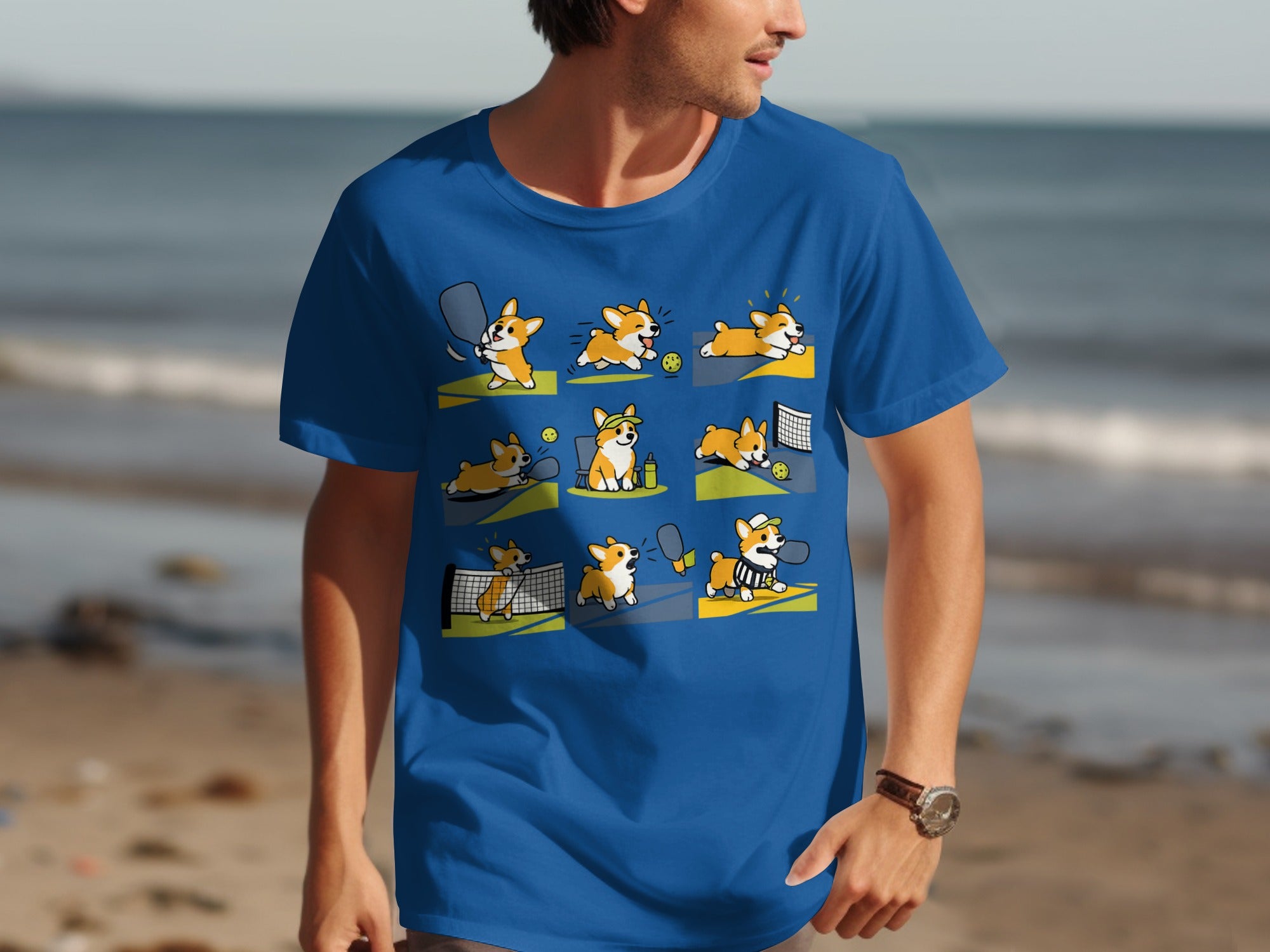 Blue t-shirt with a grid of cartoon corgis playing pickleball.