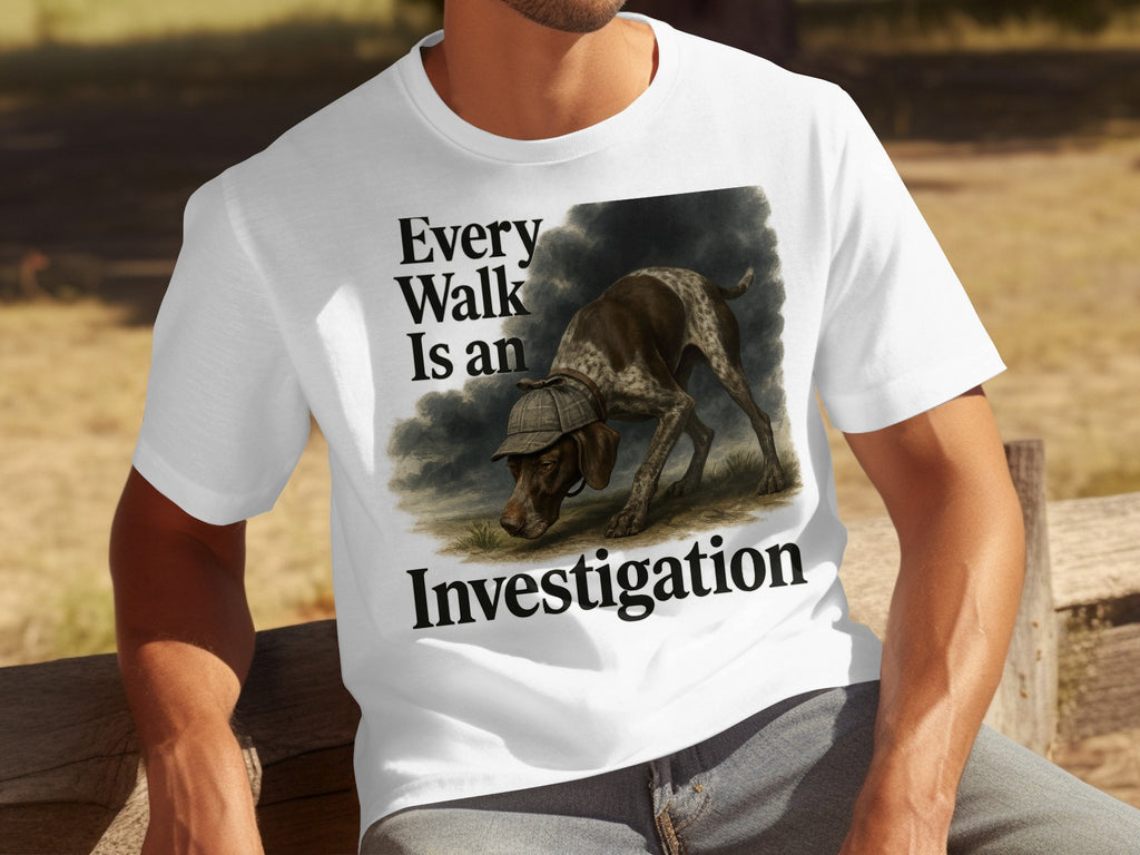 White t-shirt with German Shorthair Pointer dog wearing a deerstalker hat and text: "Every Walk Is an Investigation."