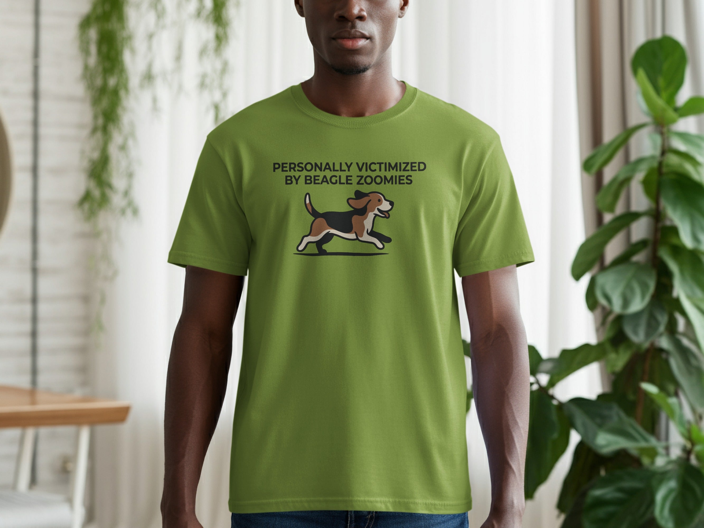 Green t-shirt with a cartoon beagle running and text "PERSONALLY VICTIMIZED BY BEAGLE ZOOMIES".