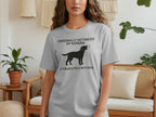 Gray t-shirt with black silhouette of barking dog and text.