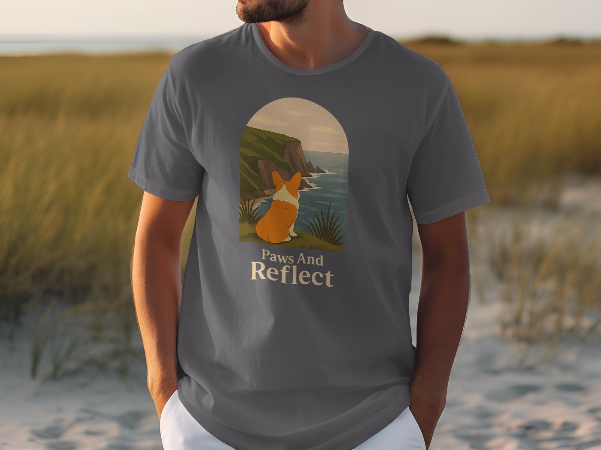 Dark grey t-shirt featuring a corgi looking at a coastal cliff scene with text.