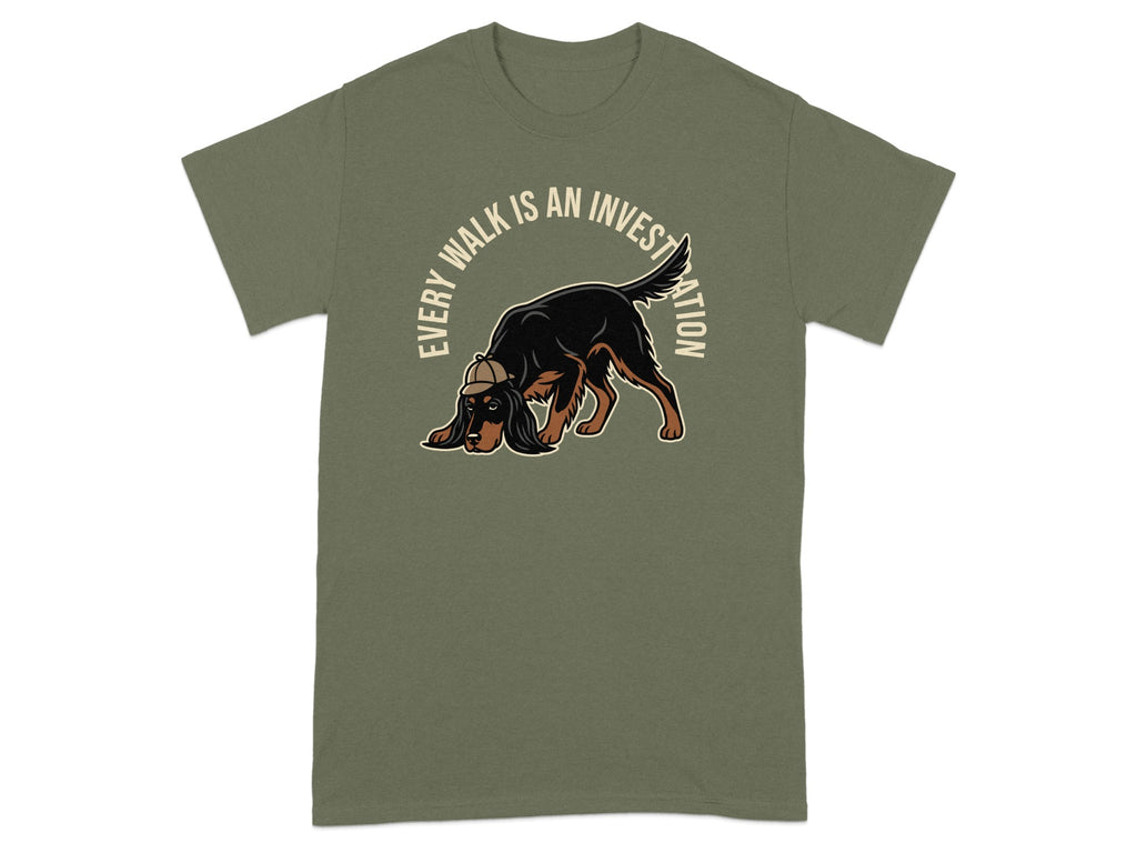 Green t-shirt with a dog wearing a hat, sniffing the ground.