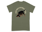 Green t-shirt with a dog wearing a hat, sniffing the ground.