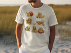 T-shirt with an illustration of seven golden retriever puppies playing with yarn and knitting supplies.