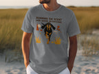 Gray t-shirt with a black and tan dog running, text "RUNNING ON SCENT AND GOOD INTENTIONS".