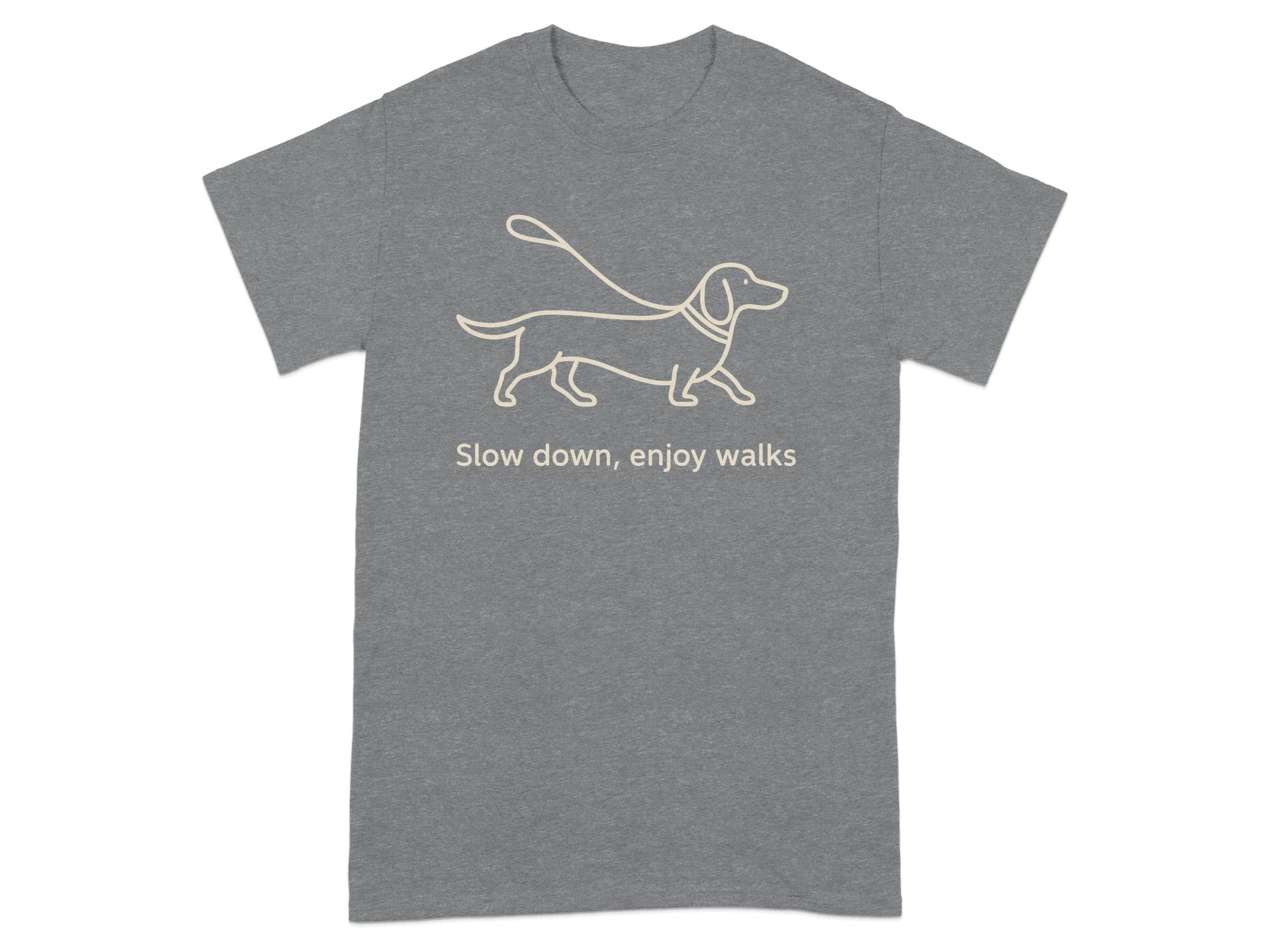 Grey t-shirt with a line drawing of a dachshund on a leash and text that reads "Slow down, enjoy walks."