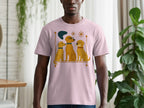 Pink t-shirt with a graphic of three cartoon dogs sitting on a shelf.
