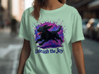 Black Labrador running through colorful paint splatters, text "Unleash the Joy".