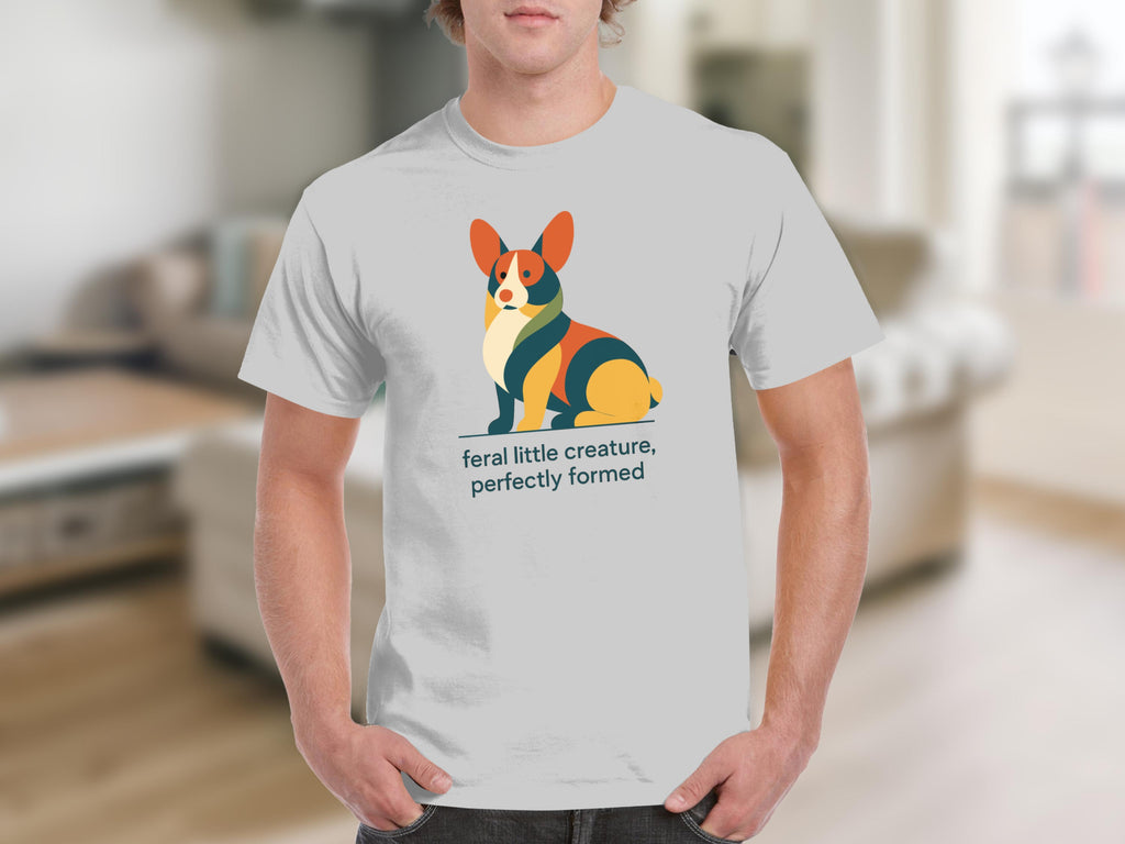 White t-shirt with a stylized corgi illustration and text "feral little creature, perfectly formed".