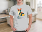 White t-shirt with a stylized corgi illustration and text "feral little creature, perfectly formed".