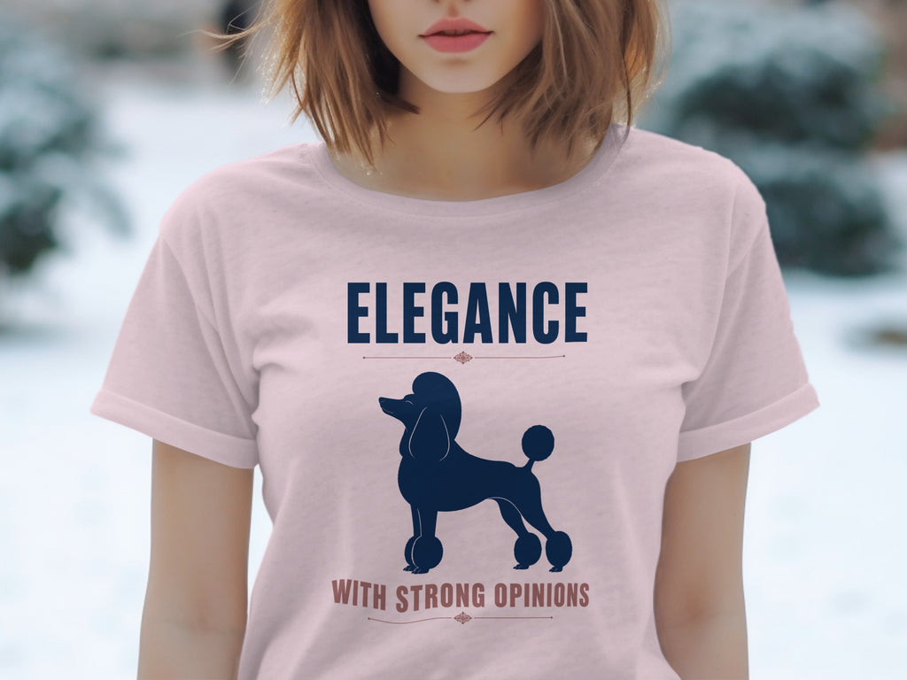 Pink t-shirt with a silhouette of a poodle and text "ELEGANCE WITH STRONG OPINIONS".