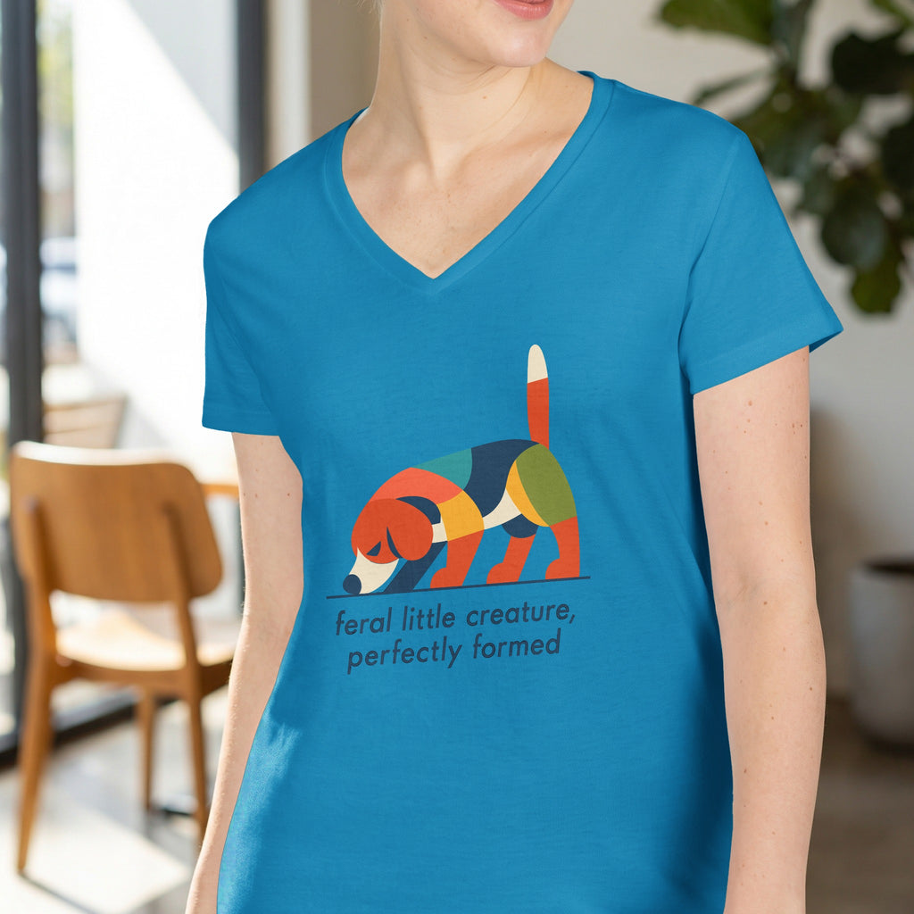 Blue t-shirt with colorful geometric dog graphic and text "feral little creature, perfectly formed".