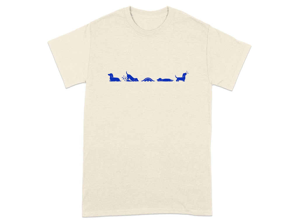 Cream t-shirt with blue dachshund illustrations in various playful poses across the chest.