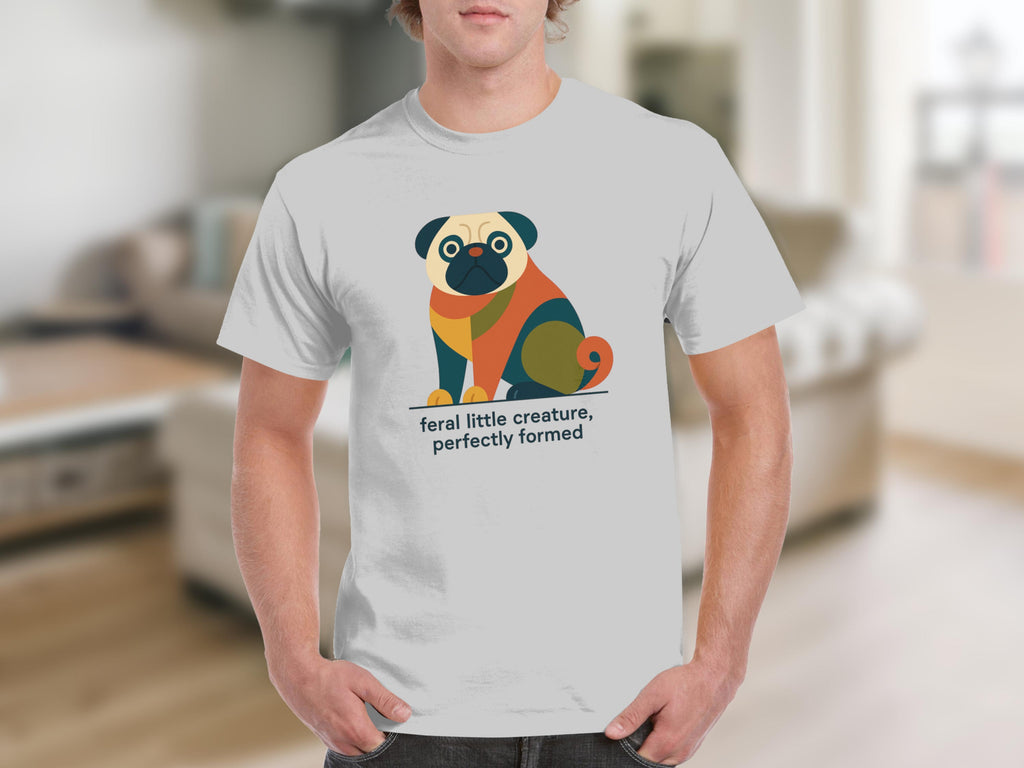 White t-shirt with graphic of a colorful pug and text "feral little creature, perfectly formed".