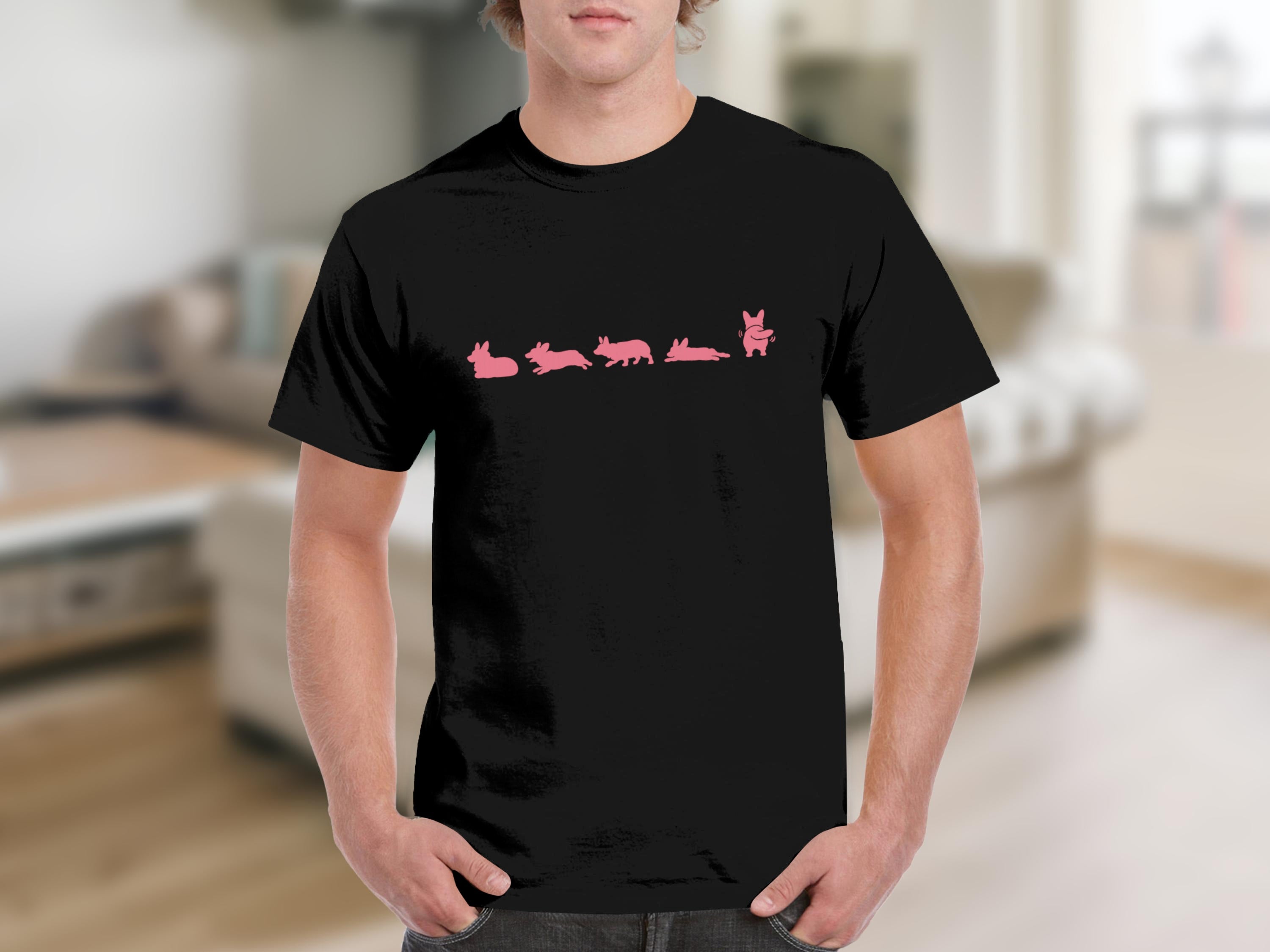 Black t-shirt with a pink graphic of corgis in various poses.