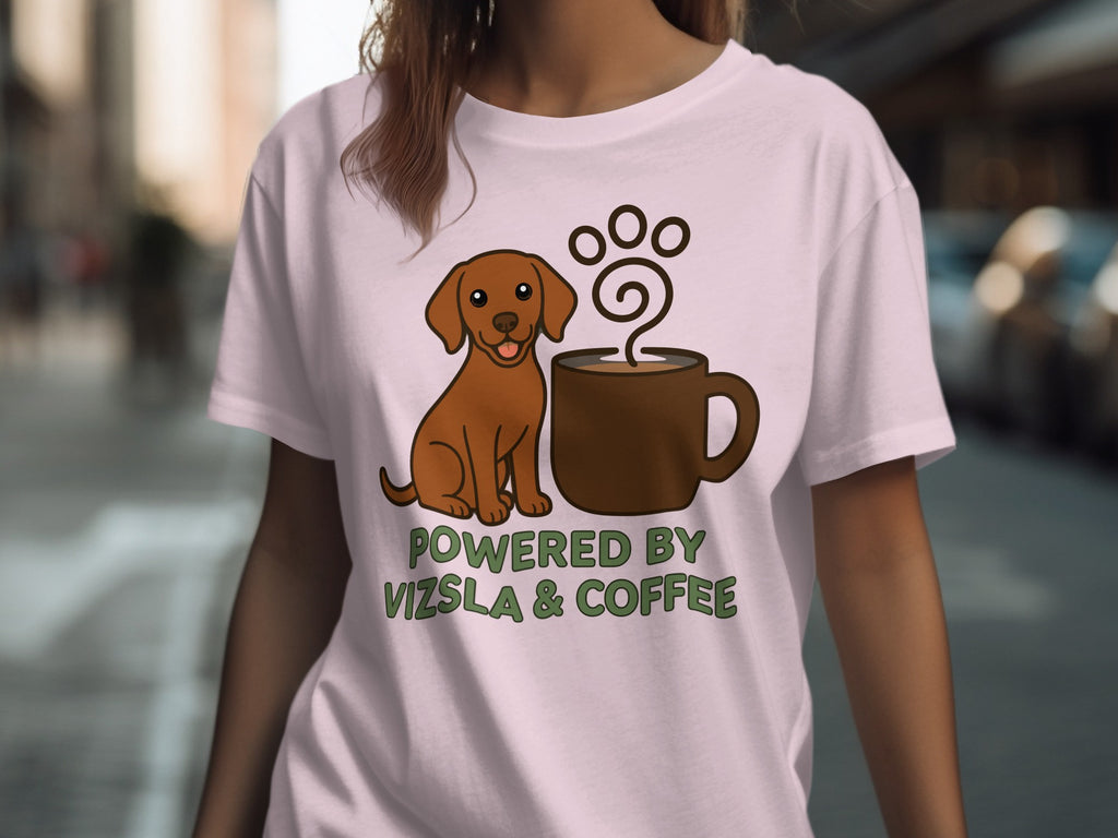 Light pink t-shirt with brown dog and coffee cup graphic and "POWERED BY VIZSLA & COFFEE" text.