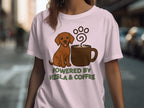 Light pink t-shirt with brown dog and coffee cup graphic and "POWERED BY VIZSLA & COFFEE" text.