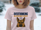 Pink t-shirt with dark blue text "OVERTHINKING ON EVERYONE'S BEHALF" and cartoon dog.