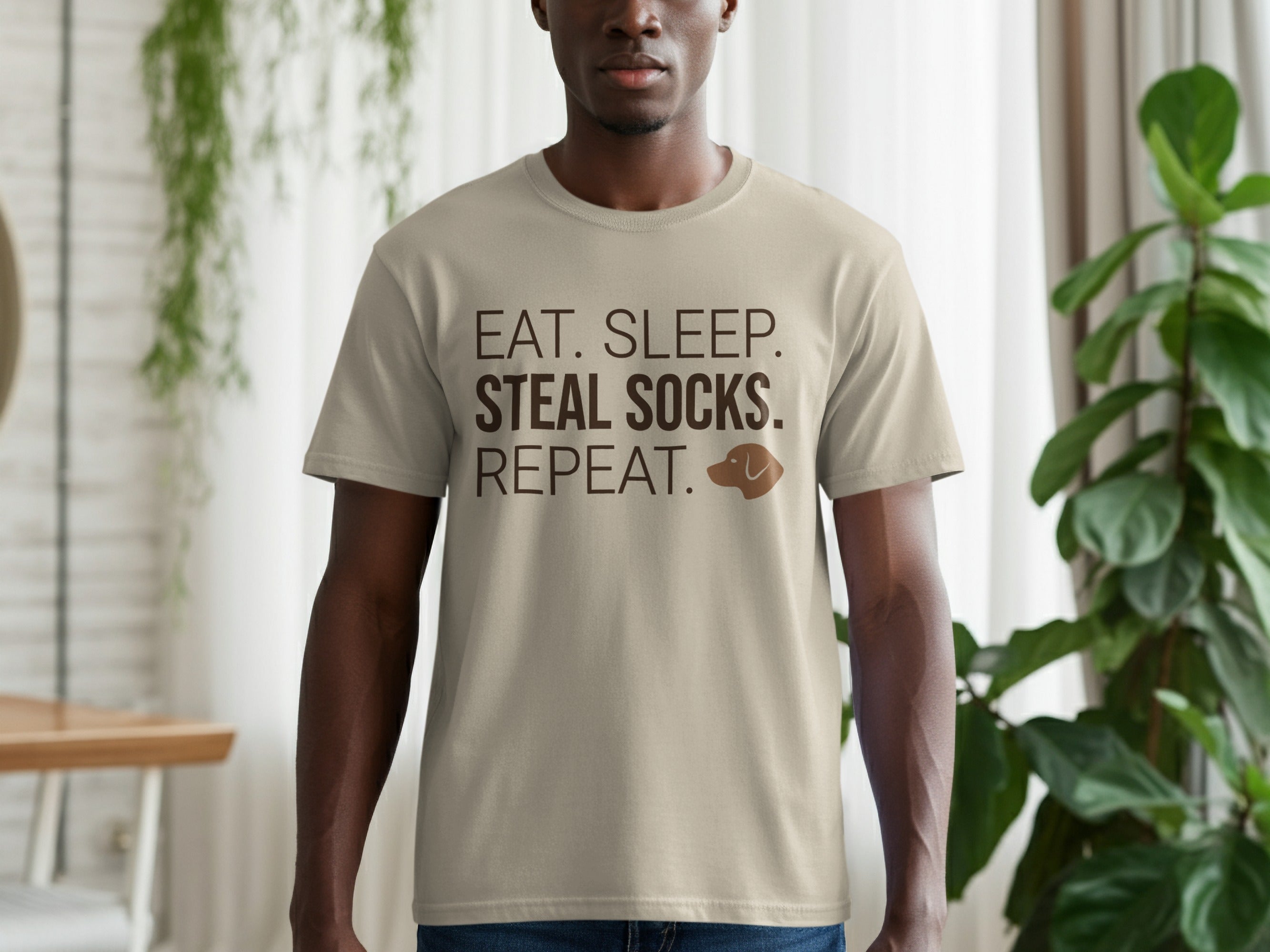 Tan t-shirt with "EAT. SLEEP. STEAL SOCKS. REPEAT." text and dog icon.