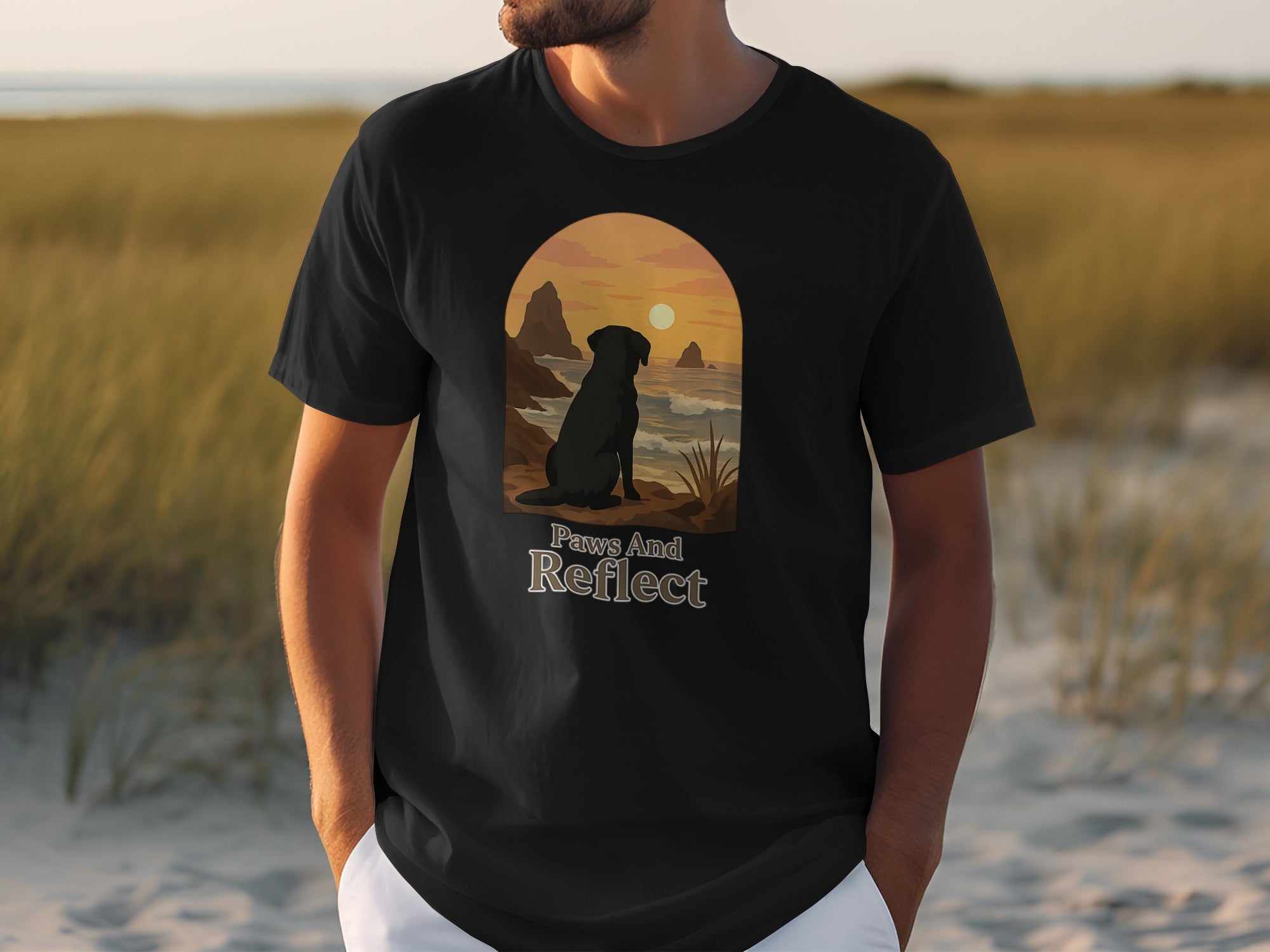 Black t-shirt with arched graphic of dog, sunset, and text "Paws And Reflect".