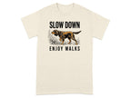 Cream t-shirt with a dog walking and text that reads "SLOW DOWN ENJOY WALKS".