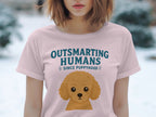 Pink t-shirt with "Outsmarting Humans Since Puppyhood" and poodle graphic.