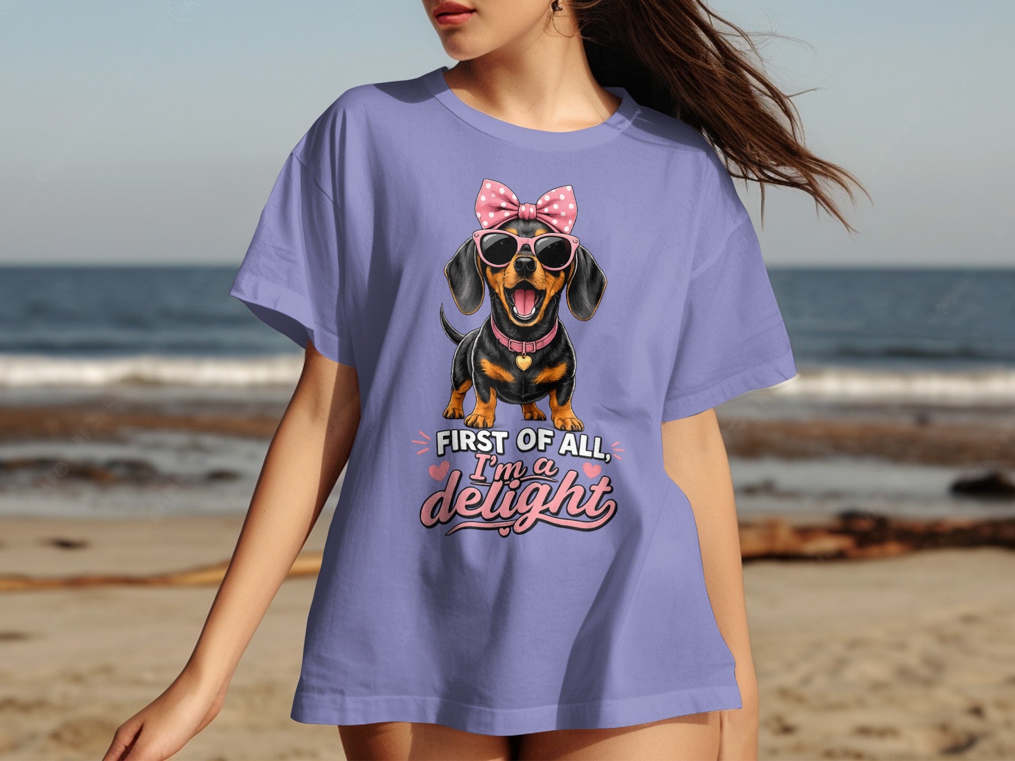 Dachshund in sunglasses and bow on purple t-shirt with text "First of all, I'm a delight."