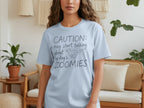 Light blue t-shirt with "CAUTION: may start talking about my dog's ZOOMIES" text and dog graphic.