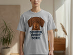 Brown dachshund on gray t-shirt with text "DEVOTED. DORXY. DORXY."