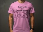 Pink t-shirt with line drawing of a dog wearing a detective hat.