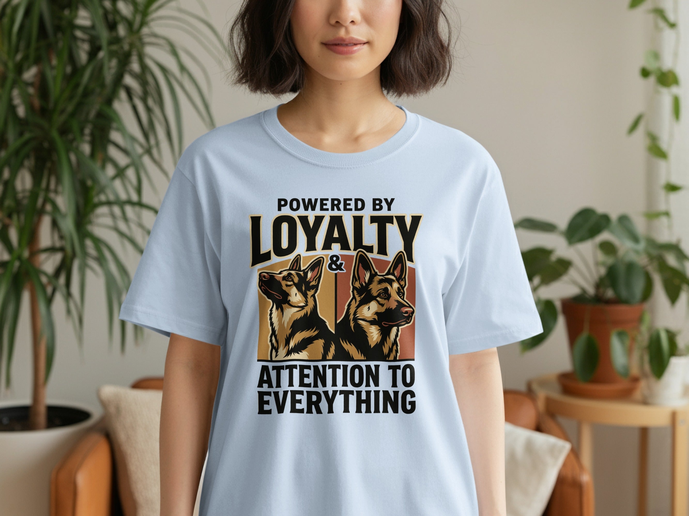 Light blue t-shirt with German Shepherd dogs and text "POWERED BY LOYALTY & ATTENTION TO EVERYTHING".