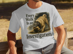 White t-shirt with a pug wearing a deerstalker hat and text reading "Every Walk Is an Investigation."