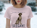 Pink t-shirt with "VELCRO, BUT MAKE IT ELEGANT" and a dog graphic.