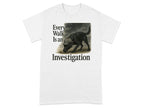 White t-shirt with text "Every Walk Is an Investigation" and a drawing of a black dog.